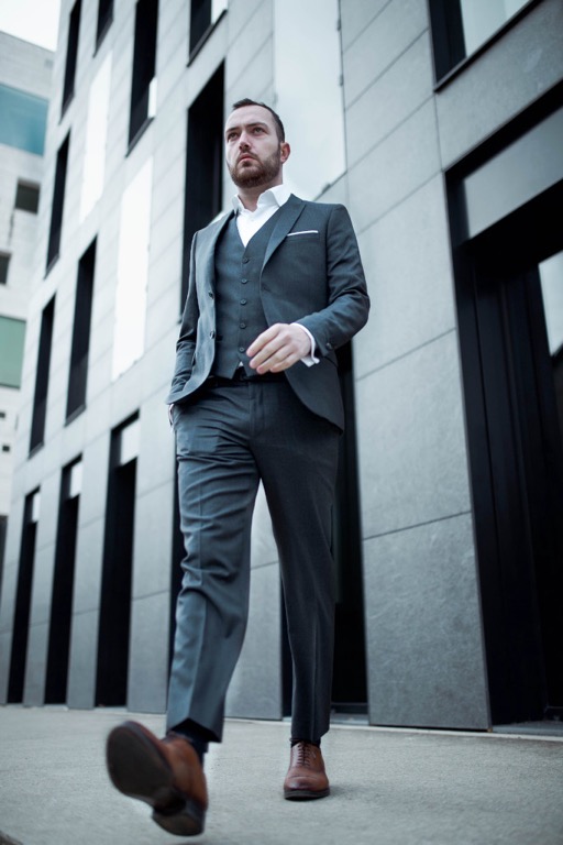 Man in business attire striding confidently